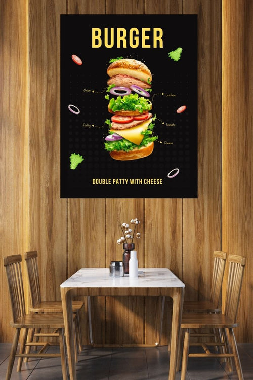 Poster of a burger with ingredients on a wooden wall above a table and chairs.
